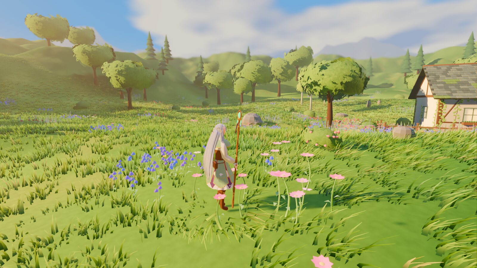 Wide view of the cottage among rolling hills and trees.